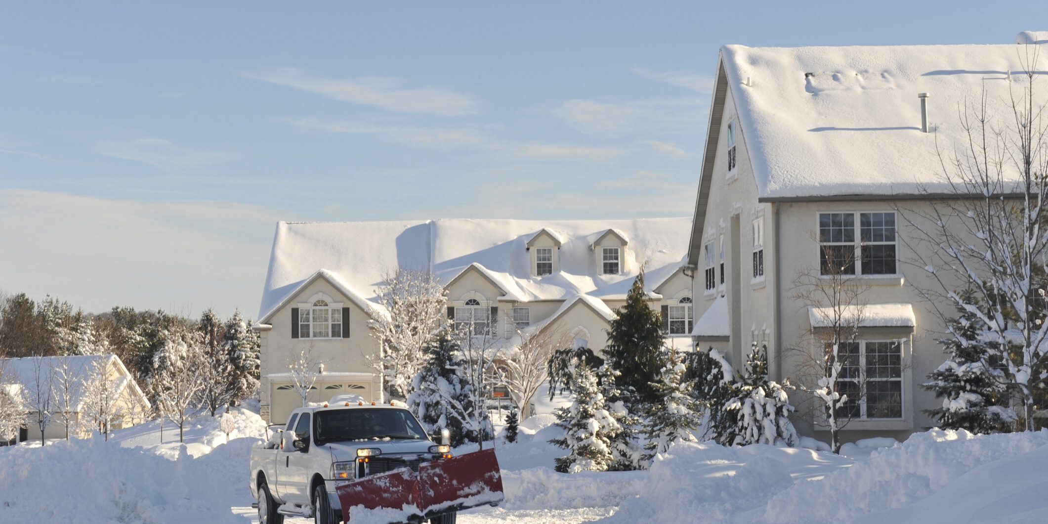 Snow plow truck in a community