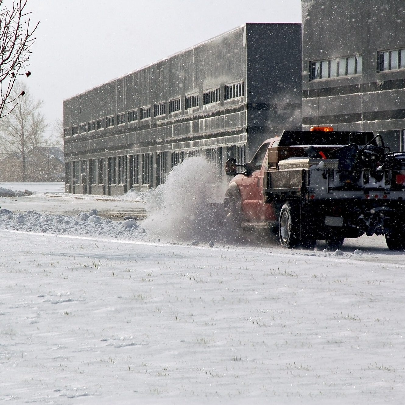 Snow plow cleaning up the parking lot.